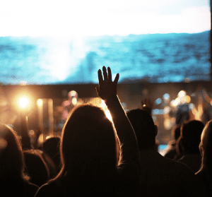 a group of people in front of a stage