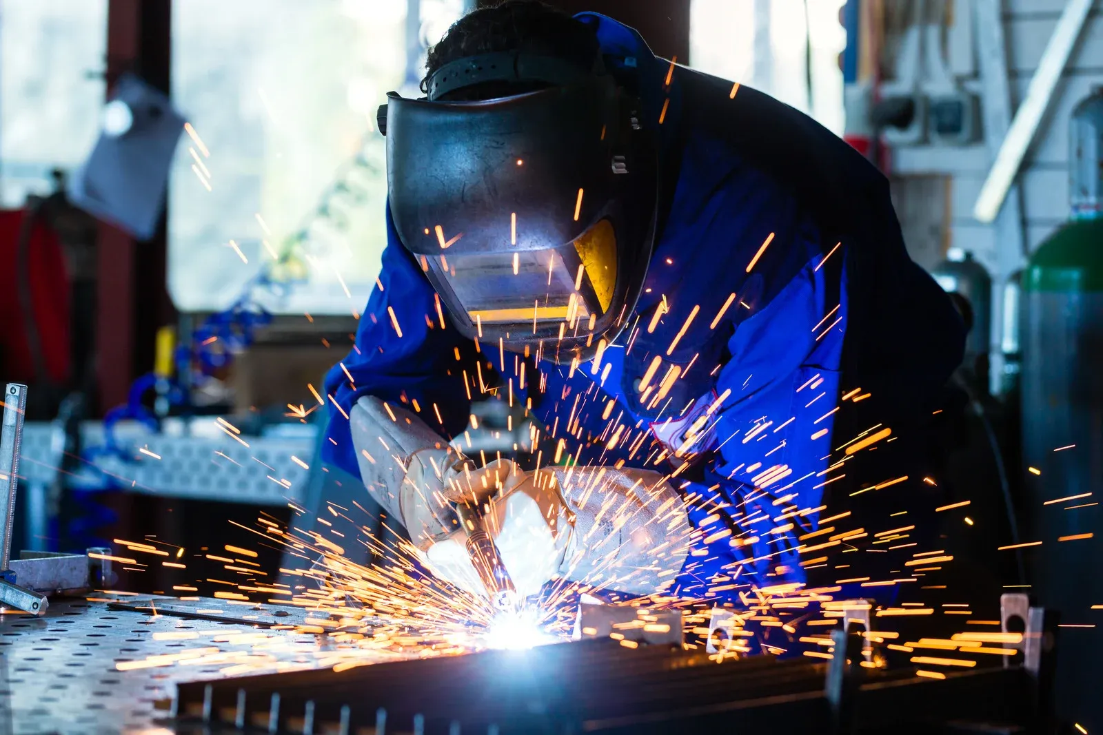 a trades person welder merging some metal piece together on a project in calgary